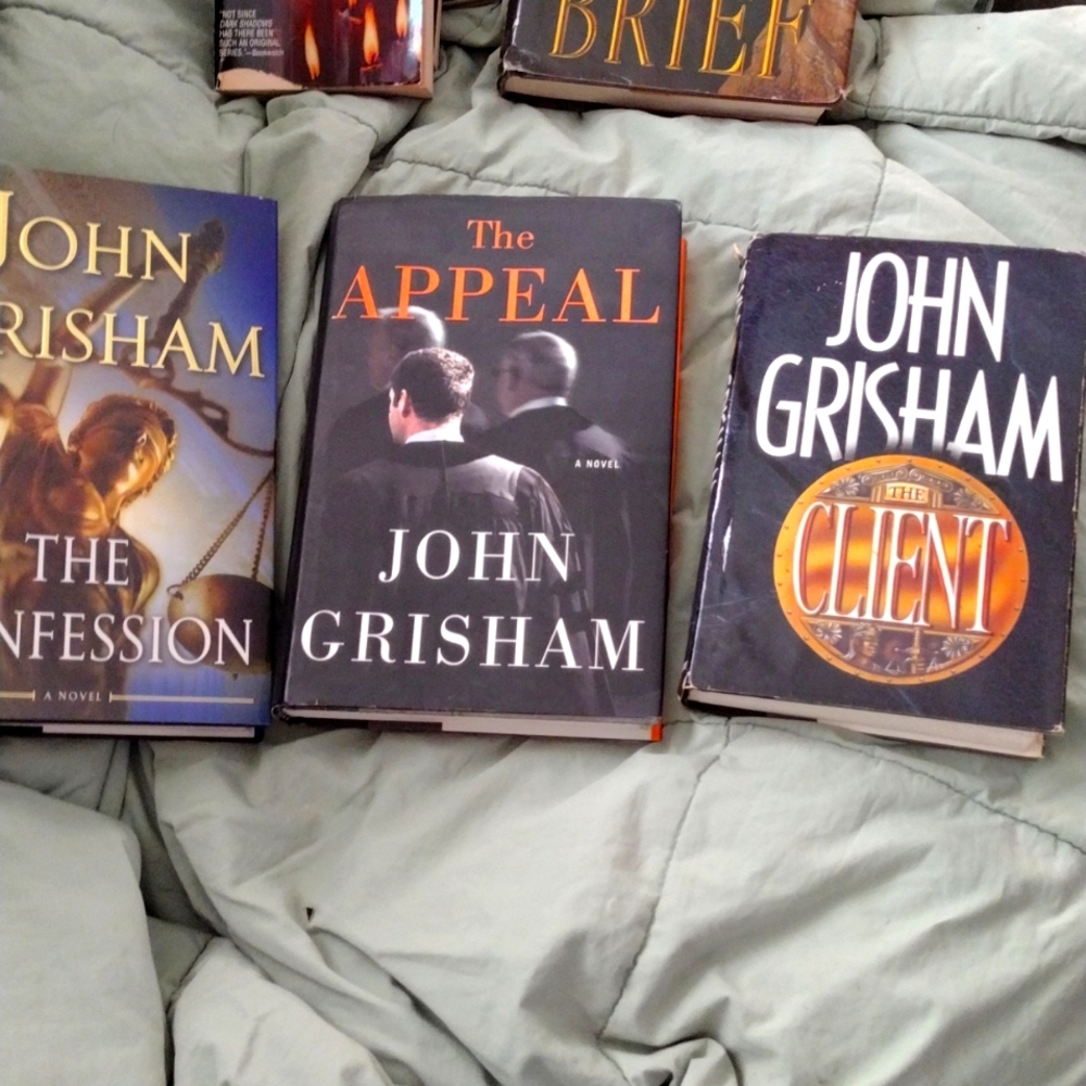 3 hardback books by John Grisham